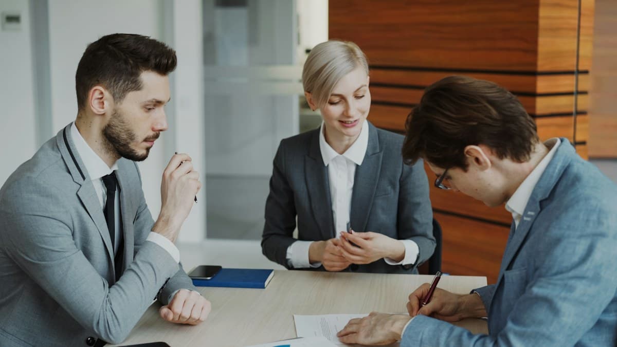 Business colleagues signing an agreement together