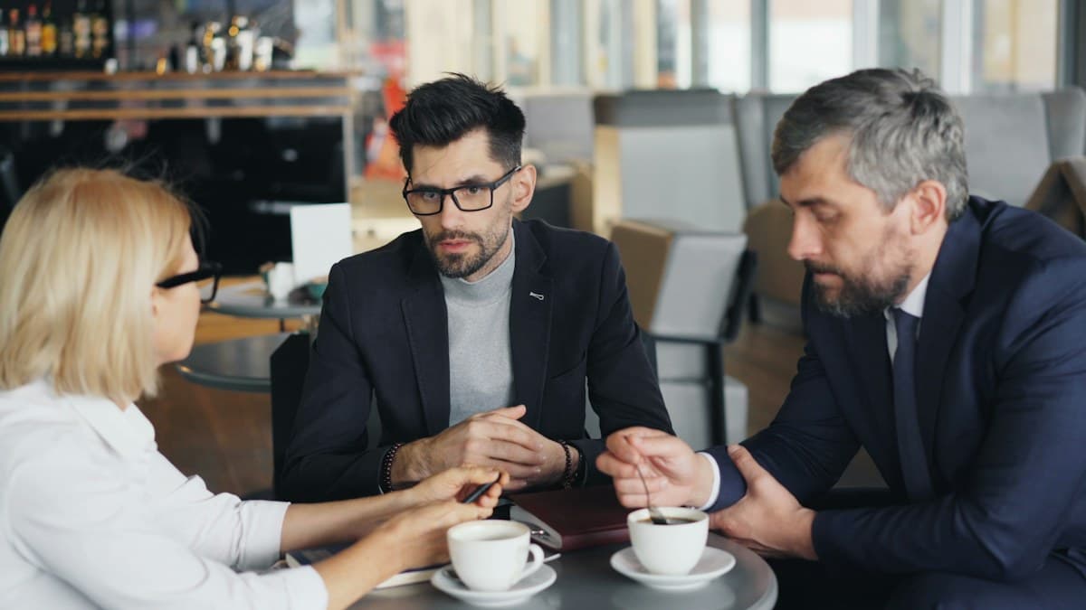 Colleagues meeting around a table in an office